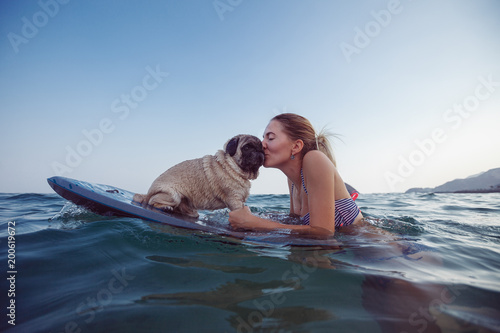 Girl with funny dog in the sea