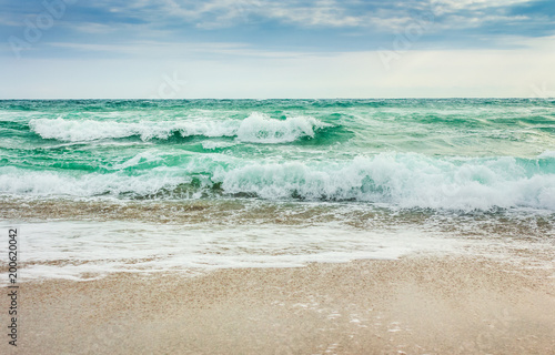 crushing waves on sandy beach. weather before the morning storm