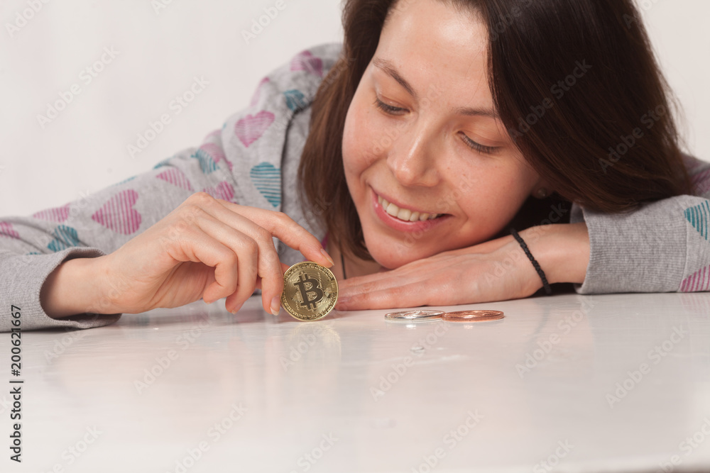 smiling beauty girl shows gold metal bitcoin smiling beauty girl shows gold metal bitcoin