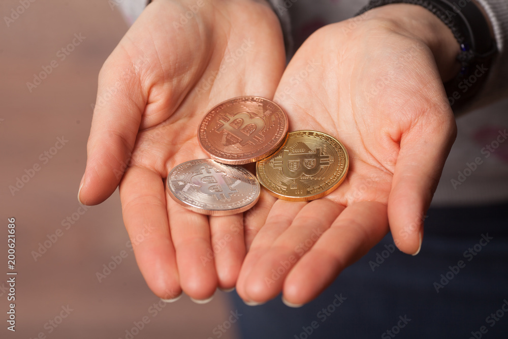 different gold silver bitcoins in opened arms different gold silver bitcoins in opened arms