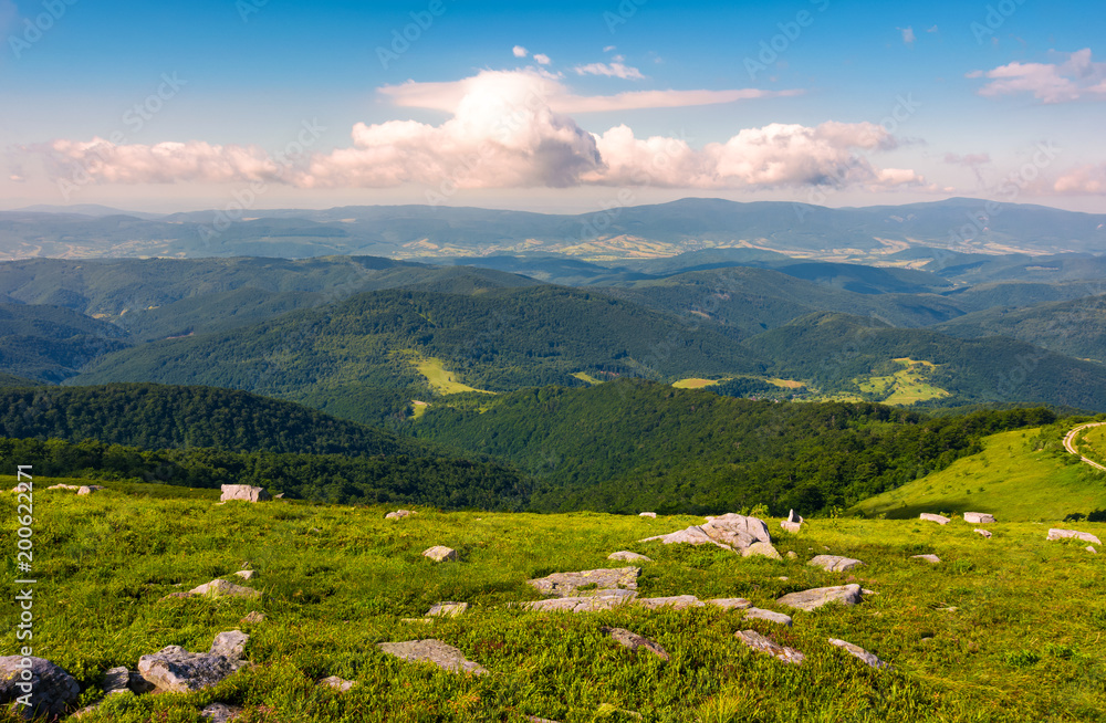 Fototapeta premium lovely landscape on Runa mountain. summer scenery on a cloudy day in beautiful light. huge rocks on a grassy meadow
