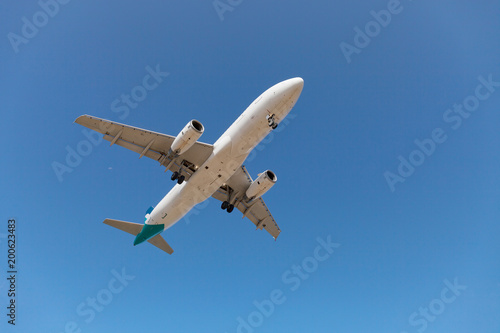 passenger airplane flying in the blue sky.