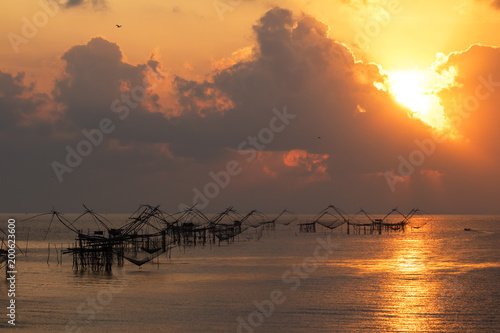 Beautiful sunrise behind fishing net at Pakpra, Phatthalung, Thailand