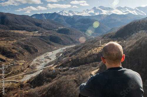 First person perspective shot from a hiker sitting at the edge of a cliff.