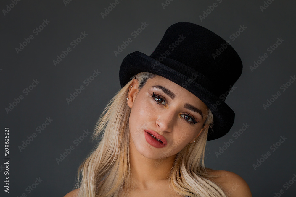 Beautiful and lovely woman portrait wearing black top hat Beautiful and lovely woman portrait wearing black top hat
