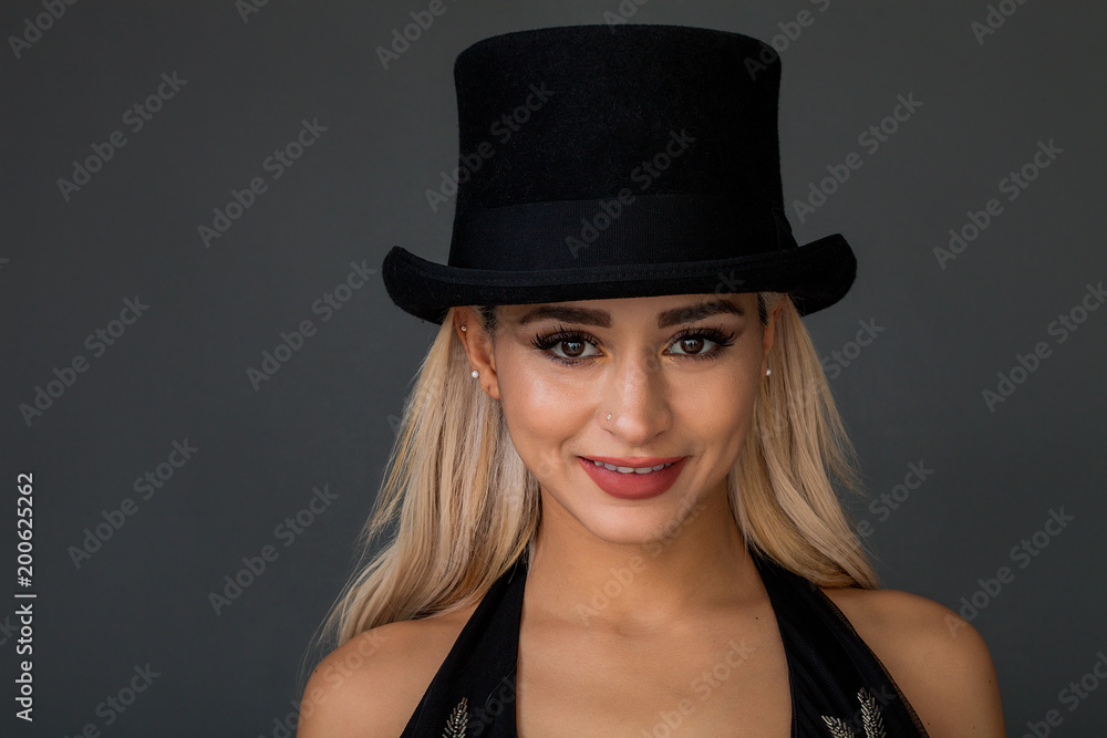 Beautiful and lovely woman portrait wearing top hat and smiling Beautiful and lovely woman portrait wearing top hat and smiling