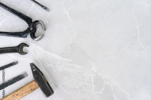 Set of tools on marble background with copy space.