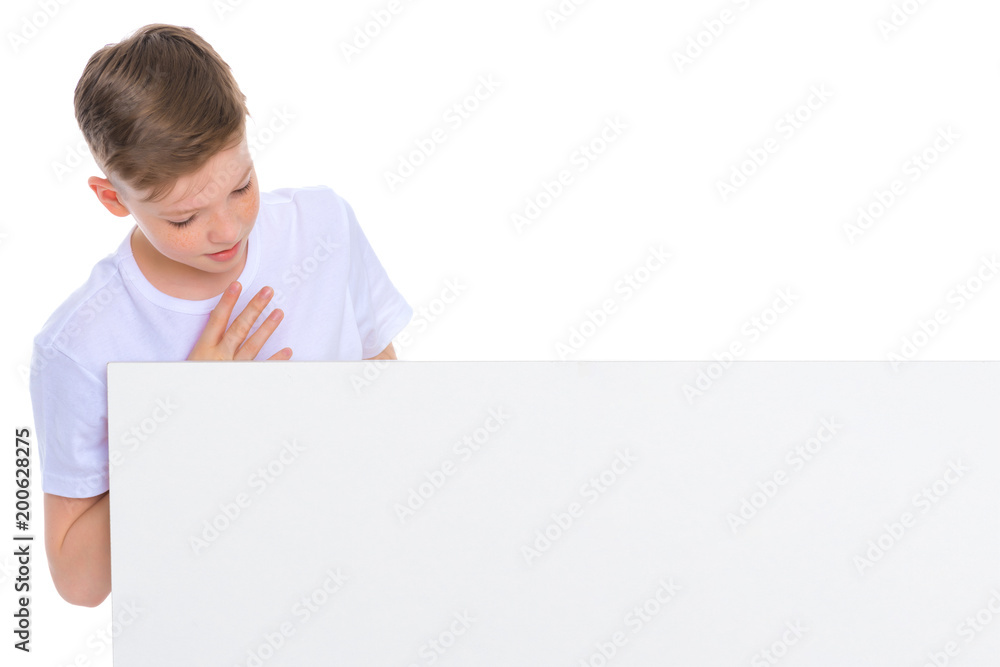 A boy of school age near a white advertising banner. A boy of school age near a white advertising banner.