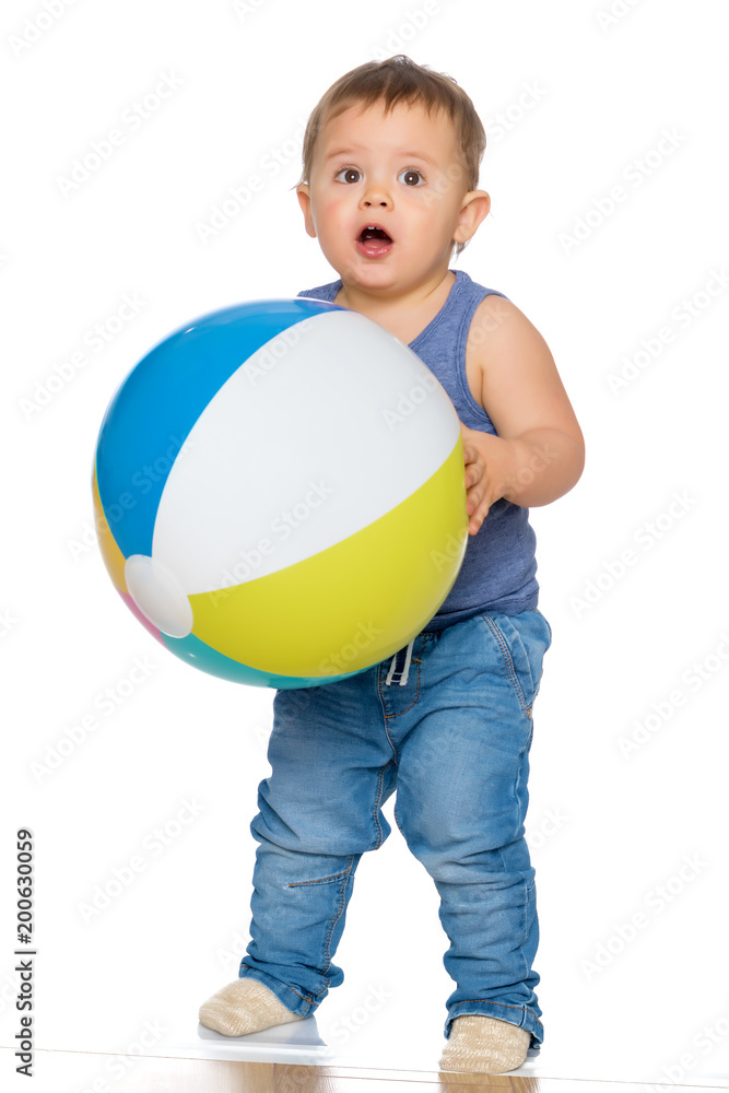 A little boy is playing with a ball. A little boy is playing with a ball.