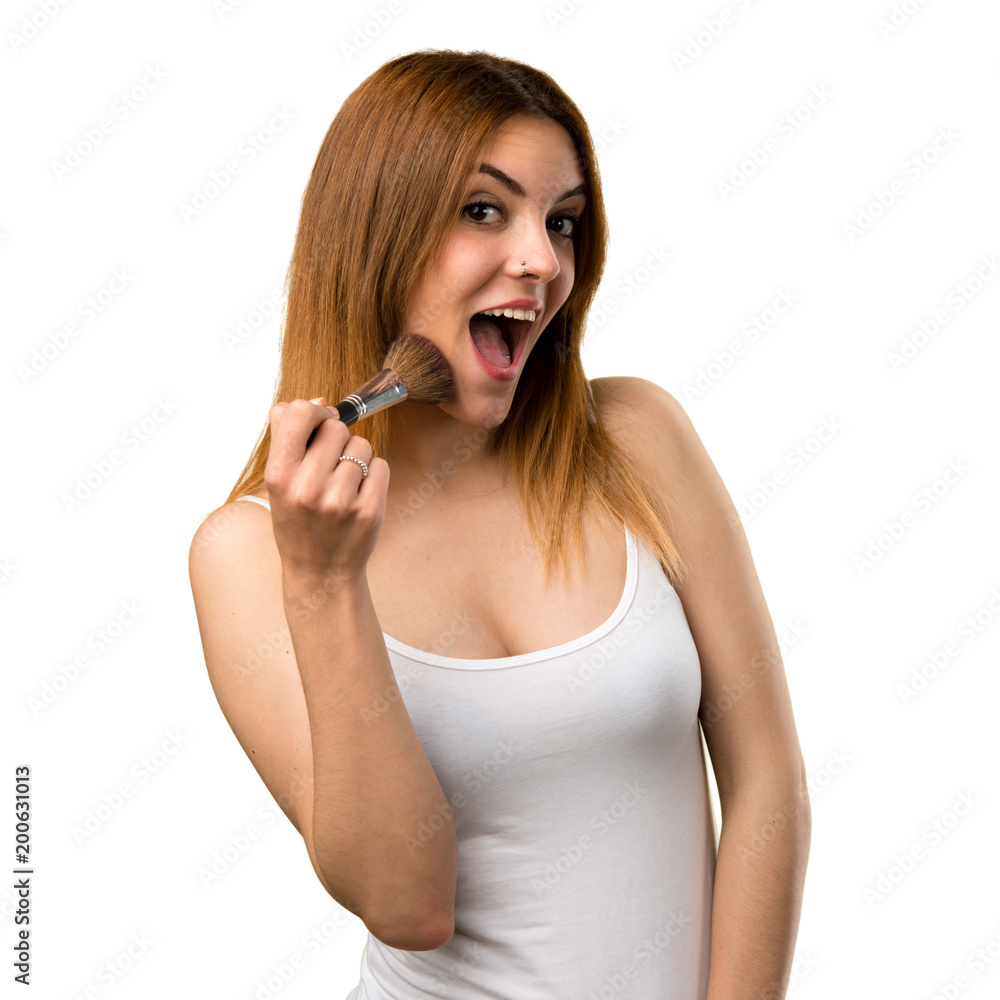 Happy beautiful young girl with makeup brush