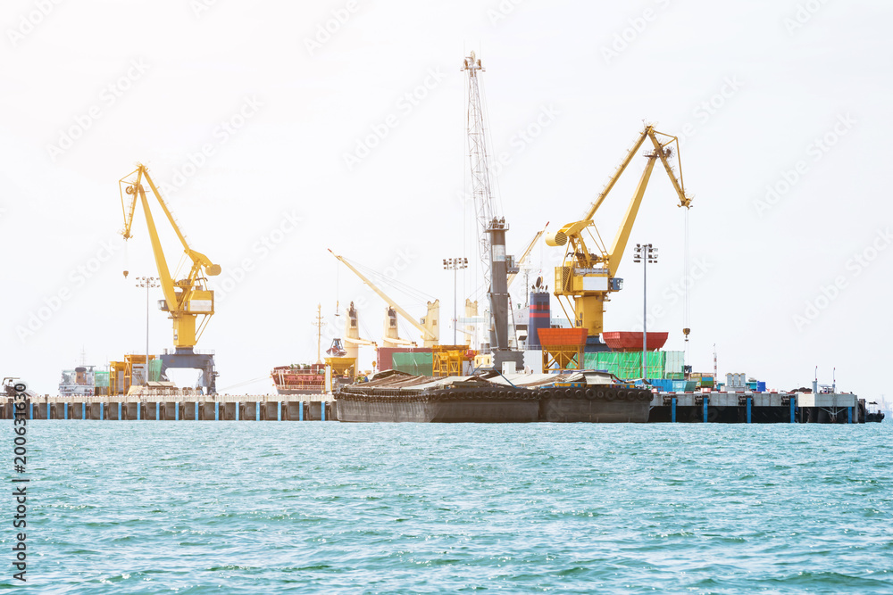 Shipping port, Crane shipping goods into cargo ship at port cargo for logistic import export in thailand Shipping port, Crane shipping goods into cargo ship at port cargo for logistic import export in thailand
