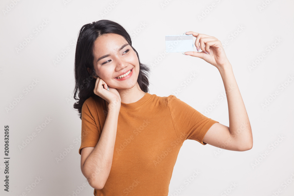 Happy young Asian woman with a blank card. Happy young Asian woman with a blank card.
