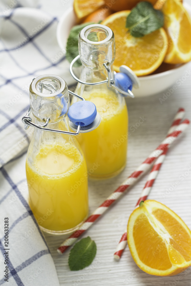 orange juice in bottles and oranges. orange juice in bottles and oranges.