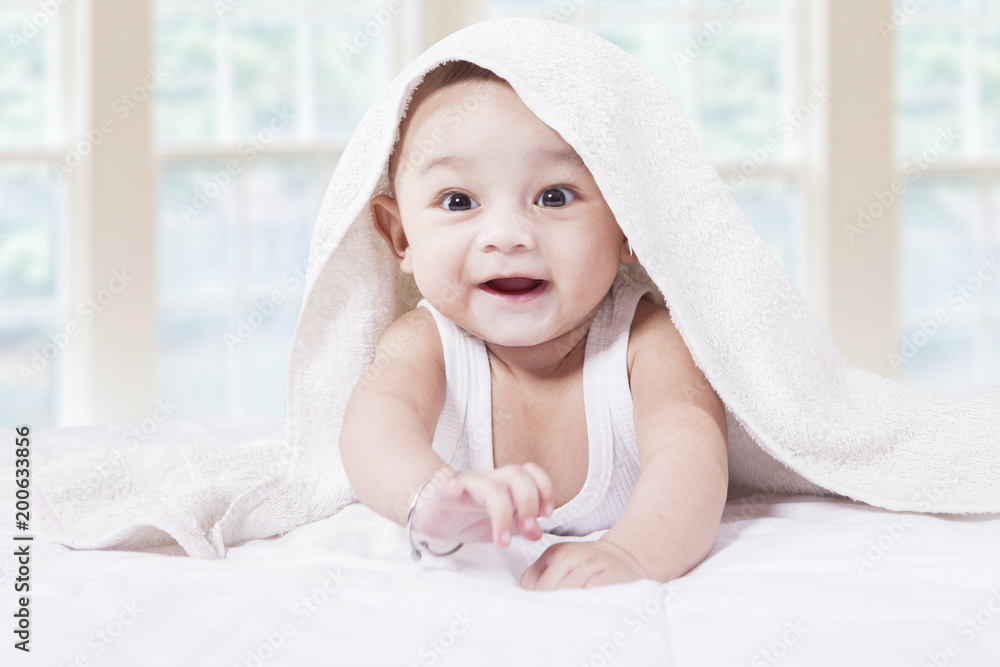 Joyful baby boy in the bedroom Joyful baby boy in the bedroom