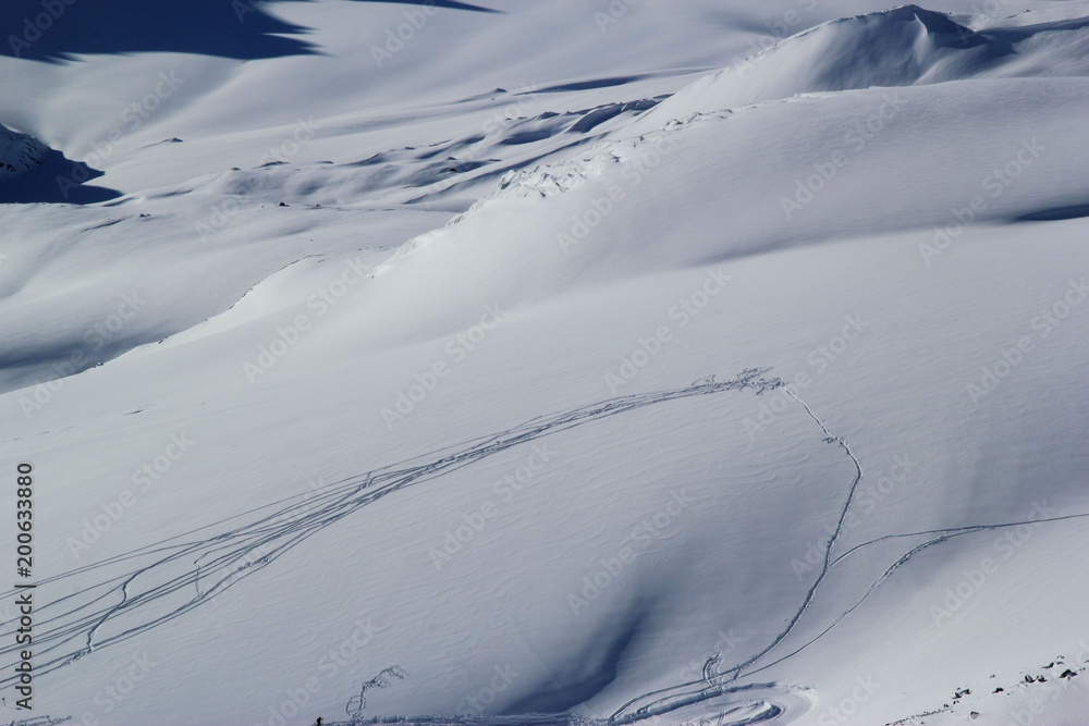 high mountains off-piste slopes for freeride with traces of skis and snowboards, sunny winter day, Caucasus Mountains, Elbrus, Russia high mountains off-piste slopes for freeride with traces of skis and snowboards, sunny winter day, Caucasus Mountains, Elbrus, Russia