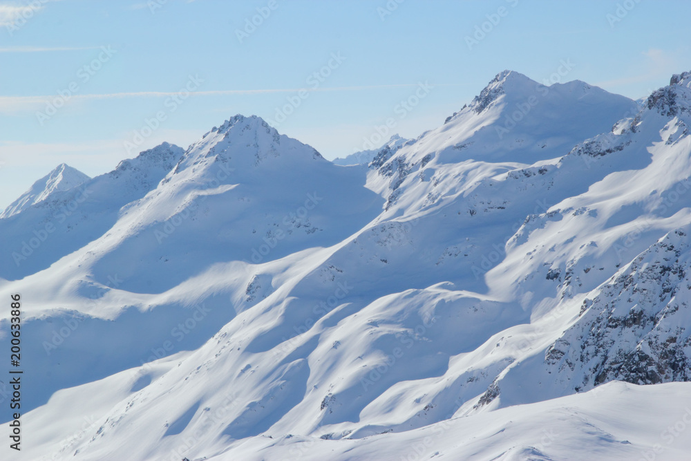 Winter landscape with snow covered peaks of Caucasus mountains, view from Elbrus mountain, Russia