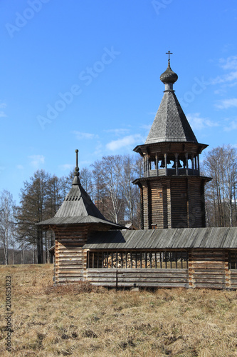 Ancient wooden church against the blue sky © Николай Григорьев