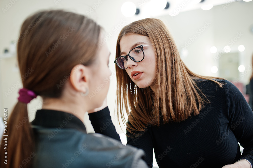 Make up artist work in her beauty visage studio salon. Woman applying by professional make up master. Beauty club concept. Make up artist work in her beauty visage studio salon. Woman applying by professional make up master. Beauty club concept.