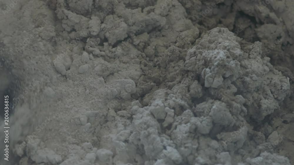 Slow motion handheld shot of mixing concrete plaster with electric mixer under flickering light Slow motion handheld shot of mixing concrete plaster with electric mixer under flickering light