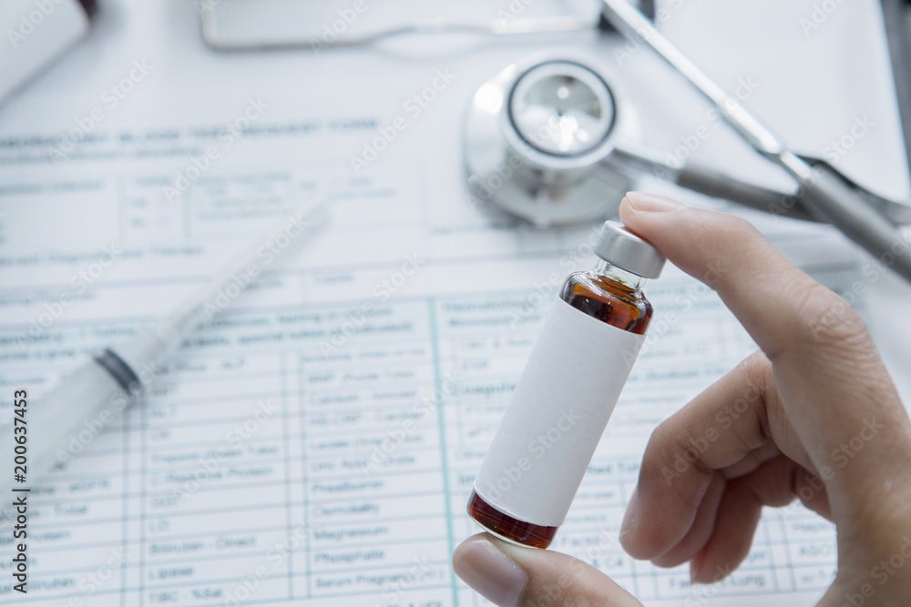 Anonymous male doctor holding a vial of medicine Anonymous male doctor holding a vial of medicine