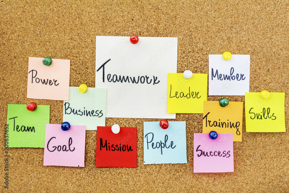 Teamwork Concept with Sticky Notes on a Cork Board Teamwork Concept with Sticky Notes on a Cork Board