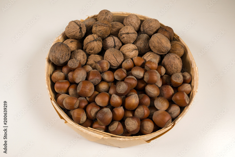 Walnuts and hazelnuts in a wicker basket. Walnuts and hazelnuts in a wicker basket.