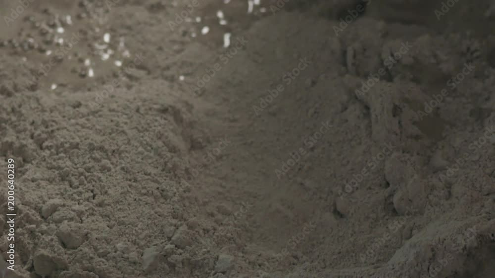 Slow motion pan shot of mixing concrete plaster with electric mixer Slow motion pan shot of mixing concrete plaster with electric mixer
