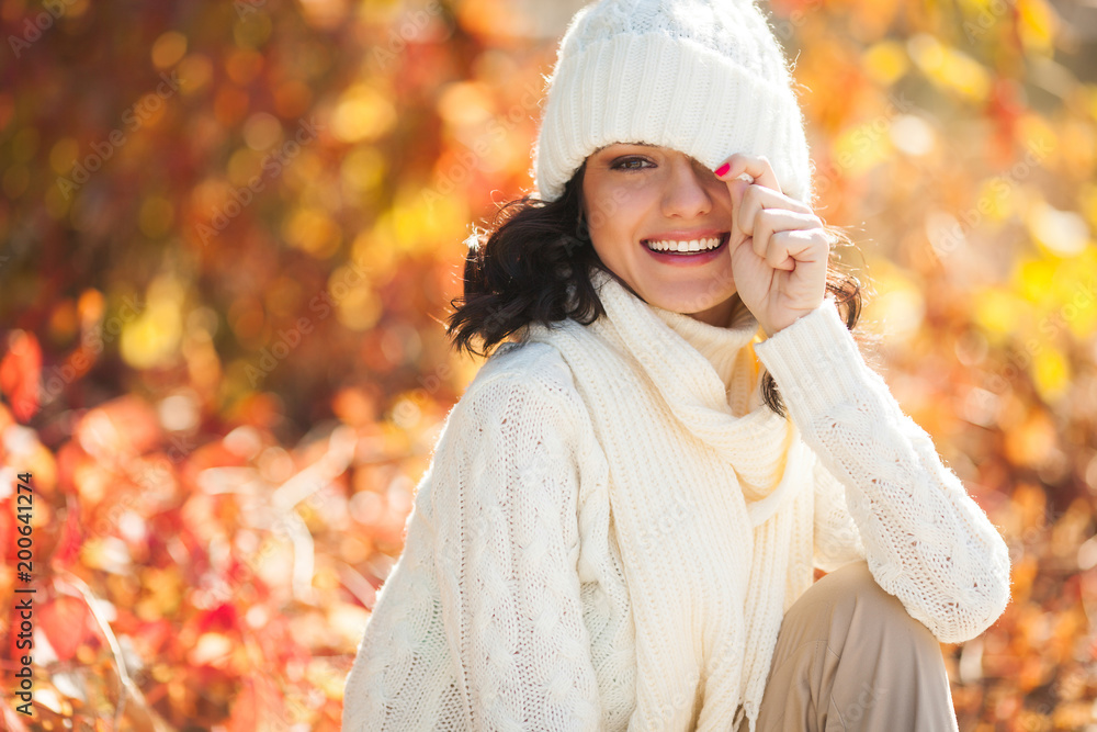 Young beautiful woman at autumn background. Portrait of attractive young girl outdoors Young beautiful woman at autumn background. Portrait of attractive young girl outdoors