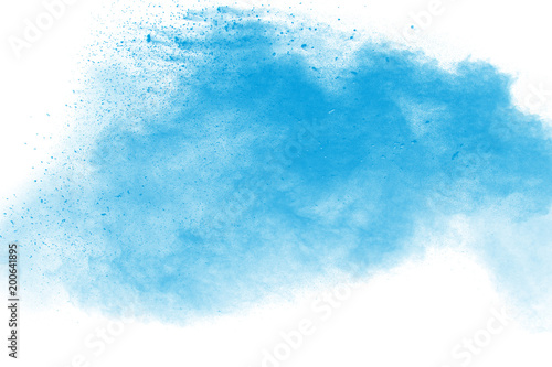 Abstract blue dust explosion on white background. Blue powder splattered on background. Freeze motion of blue powder splash. Painted Holi in festival.