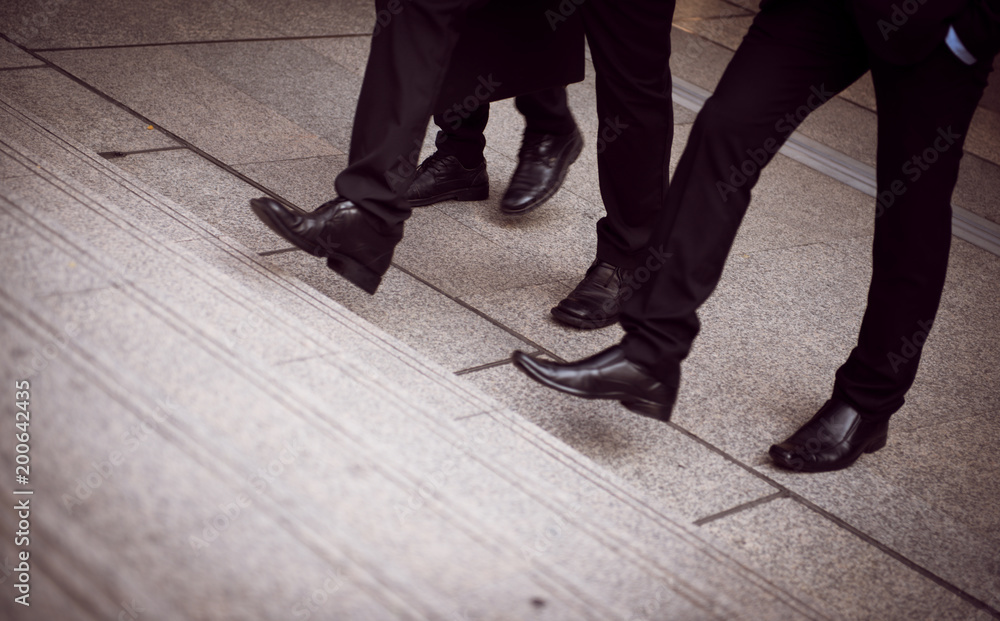 defocused or blured Businessman walking the stairs with city background, Businessmen go to success concept, vintage style.
