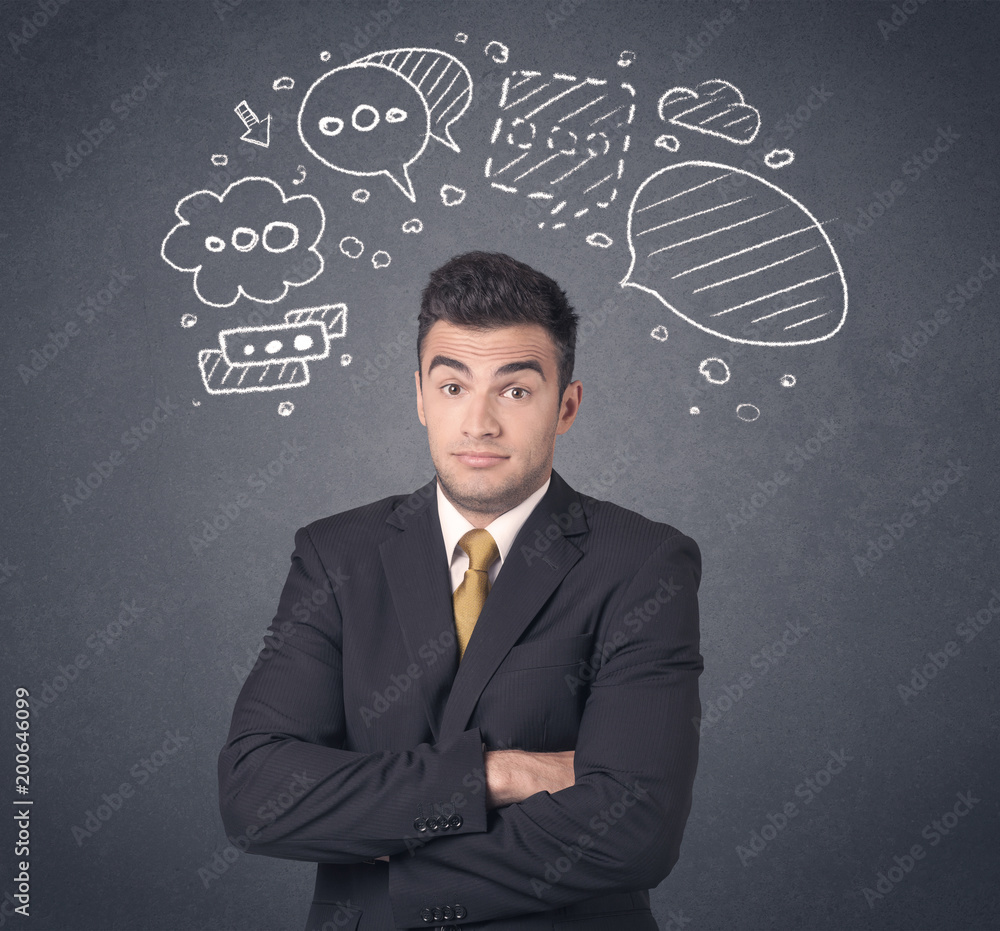 Young businessman with drawn speech bubbles over his head Young businessman with drawn speech bubbles over his head