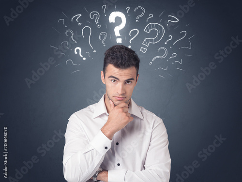 Young casual businessman with white question marks above his head