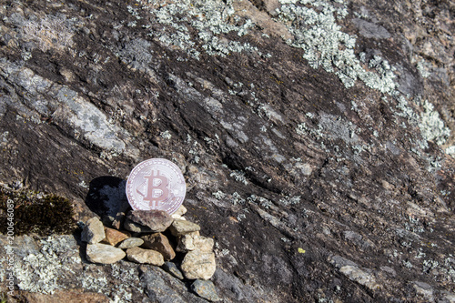 Cryptocurrency mining bitcoin in a rock background photo