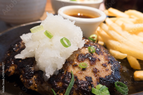 Japanese hambagu steak. Hamburger steak in Japanese style serve with fried potatoes and salad. photo