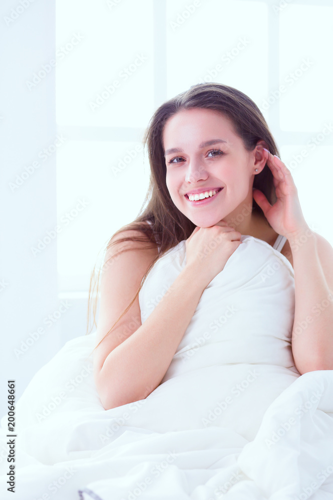 Pretty woman lying down on her bed at home Pretty woman lying down on her bed at home