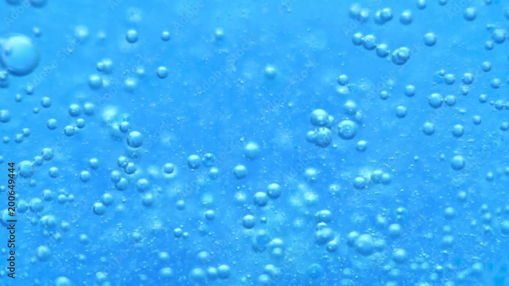 Water abstract background. Blue background. Boiling liquid. Chemical reaction in a liquid. Close-up Water abstract background. Blue background. Boiling liquid. Chemical reaction in a liquid. Close-up
