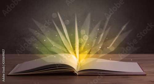 Yellow lights spreading from an open book  © ra2 studio