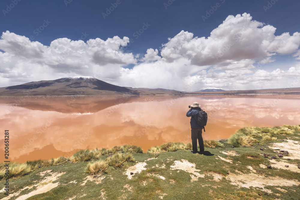 Photographer on the Colorada lagoon, Altiplano, Bolivia