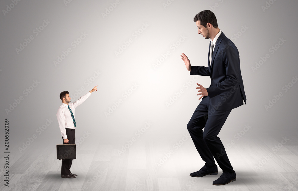Small businessman in shirt pointing to an afraid businessman
Small businessman in shirt pointing to an afraid businessman