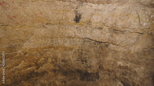 Walk through underground tunnel built in soft sandstone rock. Underground shelter for persecuted persons. Horrible wet odor.