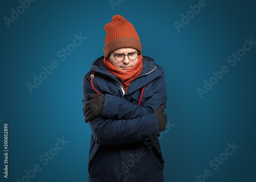 Handsome young boy freezing in warm clothing with copy space © ra2 studio