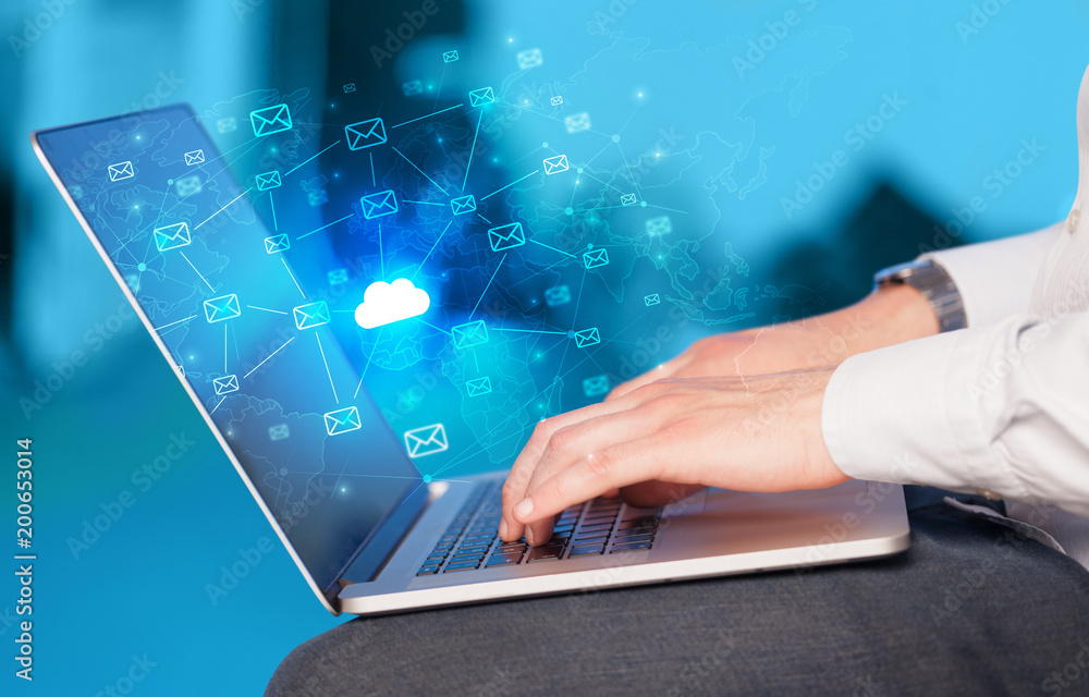 Hand using laptop with cloud computing and online storage concept
Hand using laptop with cloud computing and online storage concept
