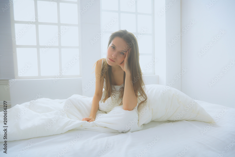Pretty woman lying down on her bed at home Pretty woman lying down on her bed at home