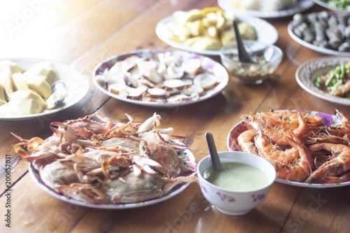 In special occasions, dishes are placed on a wooden table. sample Seafood and fruit and sauce.