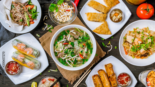 Assorted asian dinner, vietnamese food. Pho ga, pho bo, noodles, spring rolls