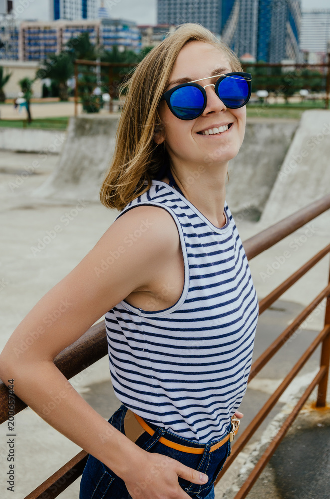 Smiling girl spending time at skateboard park