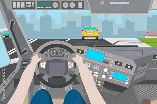 The driver is traveling in the city. City view from the cab of the truck. Vector illustration