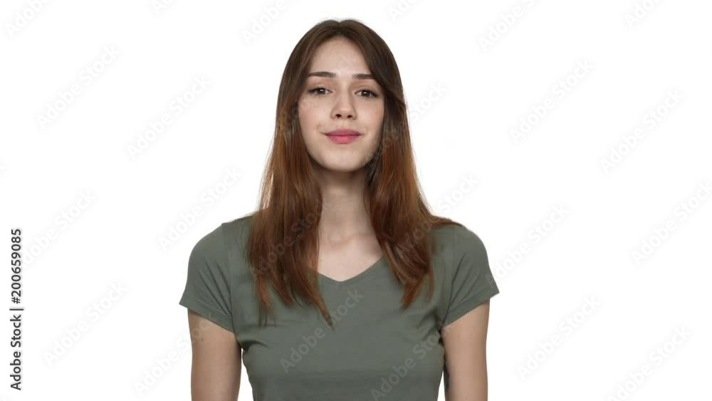 Portrait of happy woman 20s in casual clothing smiling and showing alright symbol with fingers, isolated over white background. Concept of emotions Portrait of happy woman 20s in casual clothing smiling and showing alright symbol with fingers, isolated over white background. Concept of emotions