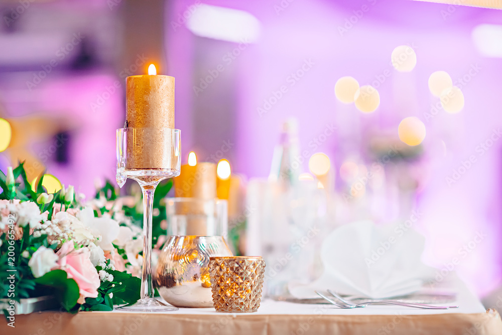 Wedding table decorated with flowers and candles Wedding table decorated with flowers and candles