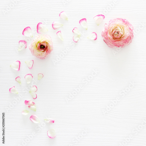 Wallpaper Mural Image of delicate pastel pink beautiful flowers arrangement over white wooden background. Flat lay, top view. Torontodigital.ca